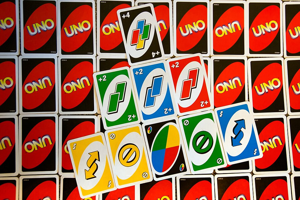 Uno action cards laid out on top of face-down Uno cards: Draw Two, Wild Draw Four, Skip, Reverse and Wild